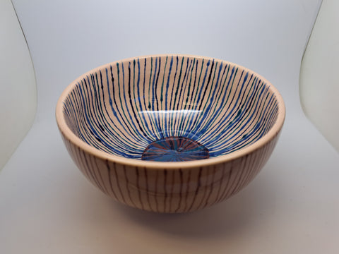 Ceramic light brown bowl with red and blue stripes